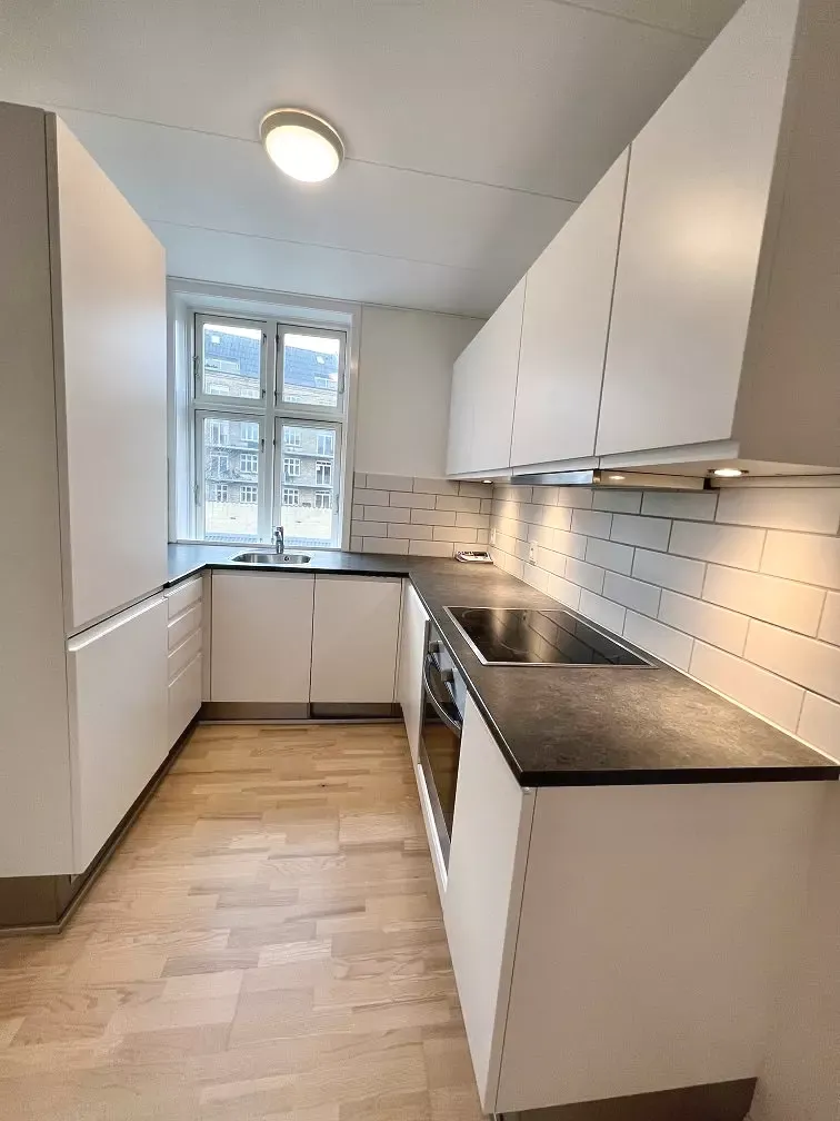 Lys 2-værelses på 71 m2 i klassisk ejendom med moderne køkken og grøn gård